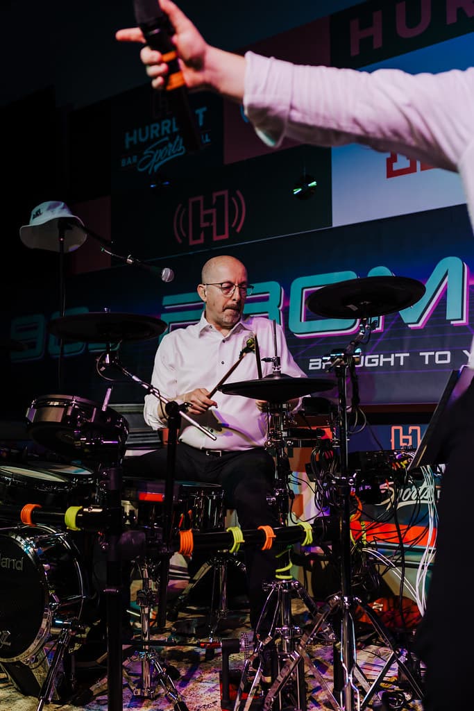 Lead singer backlit by a dramatic light rig