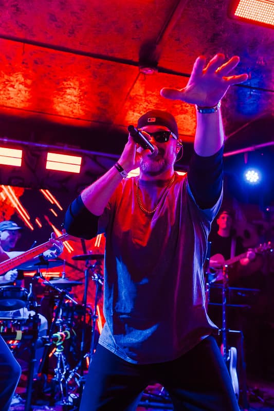 Vocalist commanding the stage under red and blue lights