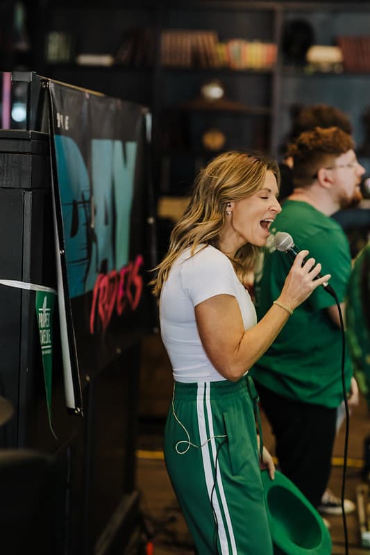 Singer belting it out with band rocking behind her