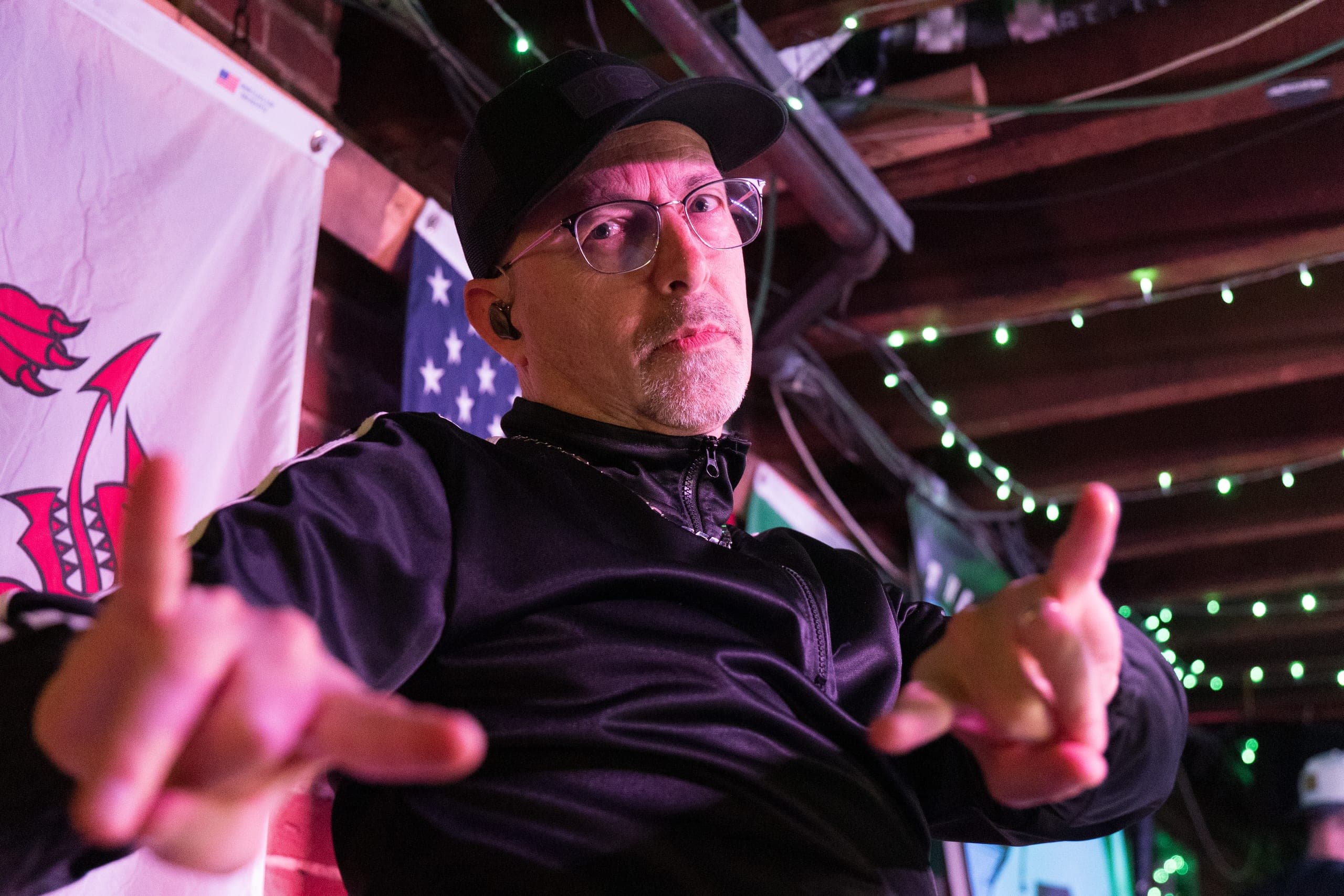 Vocalist throwing his hands up during a high-energy pub show